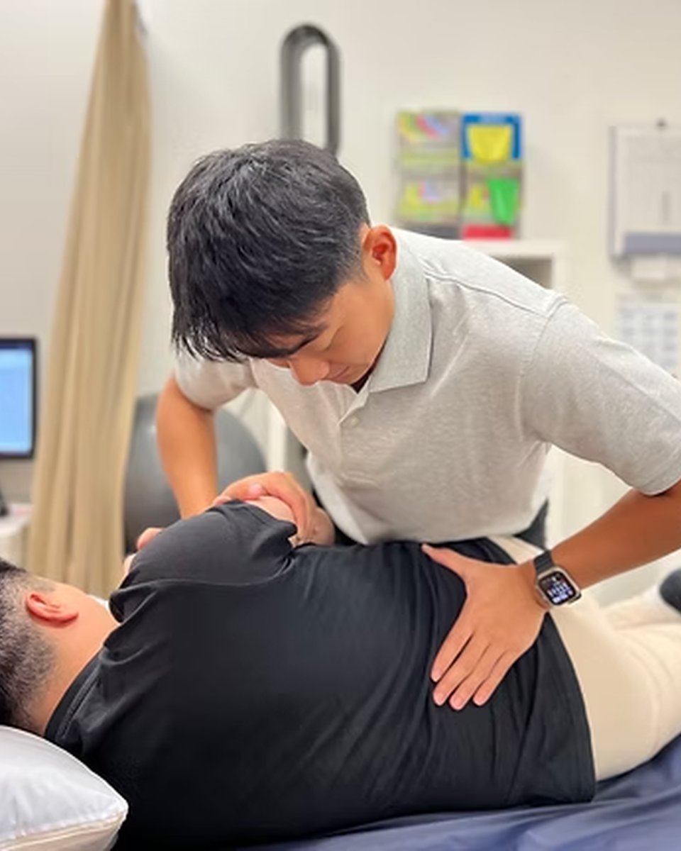 A chiropractor treating a patient in one of the treatment rooms at Wally's Health Clinics, Darling Square.